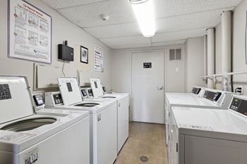 Shared laundry room with washers and dryers
